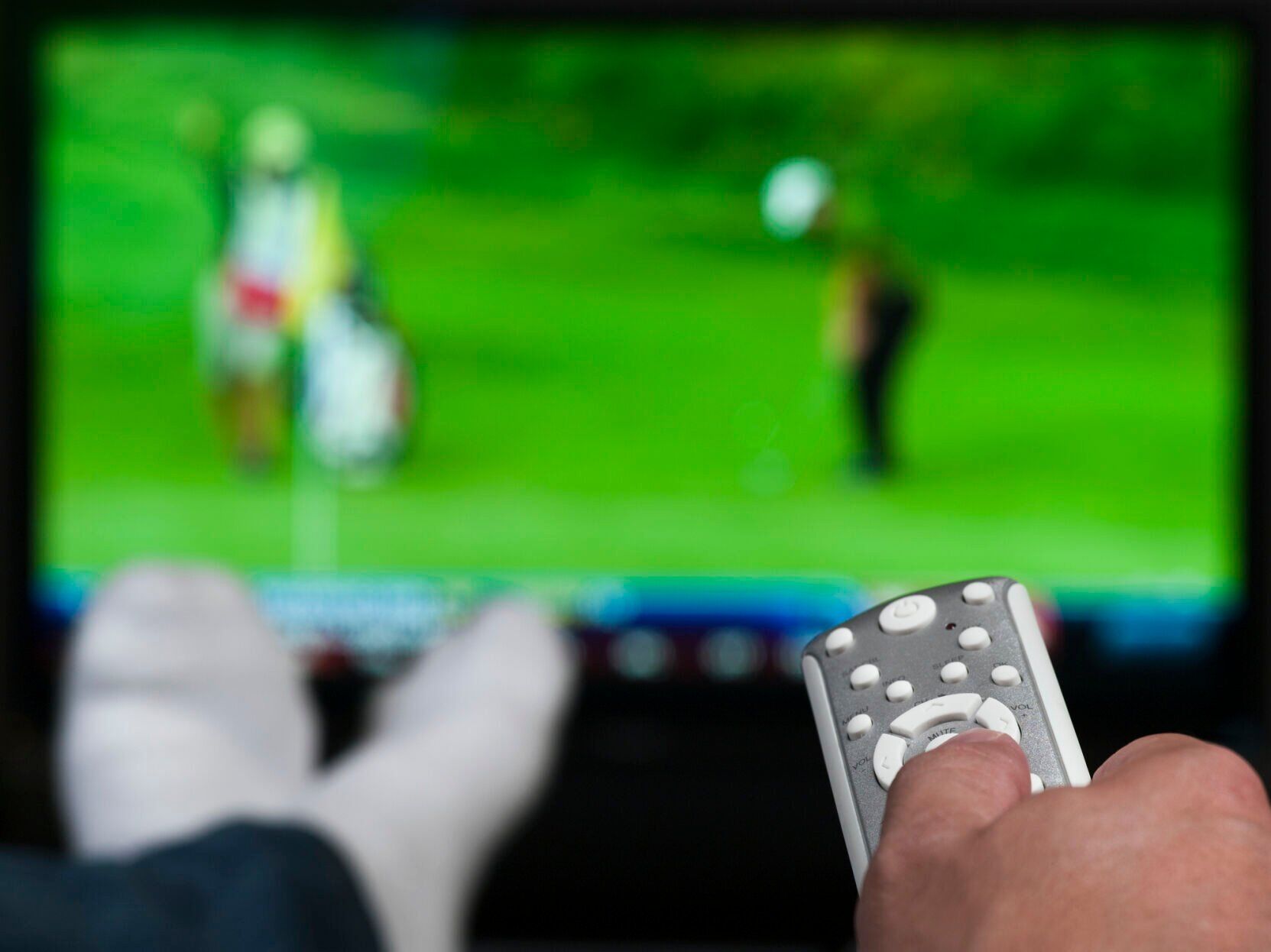 Hand holding a tv remote control